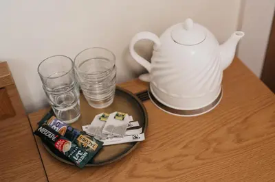 a table with a tea pot and glasses on it at CATHEDRAL Old Town Suites in Vilnius