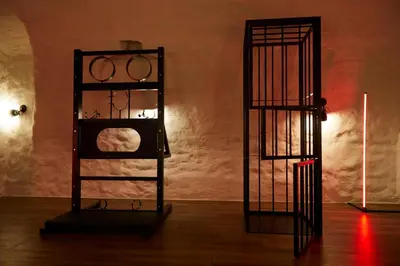 a room with two iron shelves and a candle at BDSM Black Apartments in Vilnius