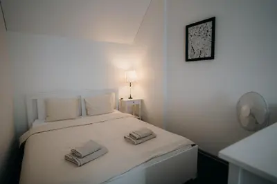 a bedroom with a bed with two towels on it at Resort Stories Išskirtiniai 7 vietų apartamentai Birštone in Birštonas
