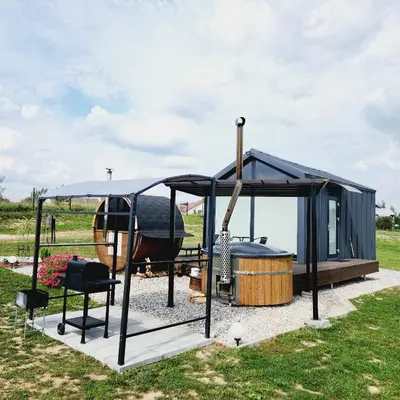 a playground with a black canopy and a swing at Vipoilsis Namelis N1 in Čekoniškės