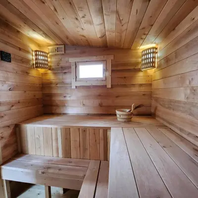 an inside of a wooden sauna with a bench at Vipoilsis Namelis N1 in Čekoniškės