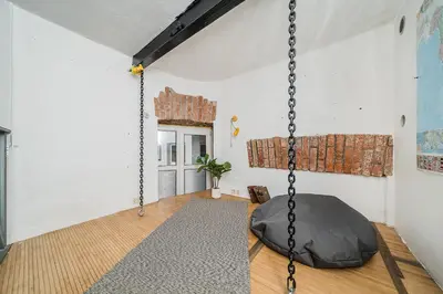 a room with a black swing in a room at Quiet and Cosy apartment in Kaunas Old Town in Kaunas