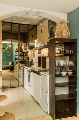 a large kitchen with white appliances in a room at Quiet and Cosy apartment in Kaunas Old Town in Kaunas
