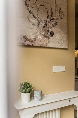 a shelf with two vases and a painting on a wall at Quiet and Cosy apartment in Kaunas Old Town in Kaunas