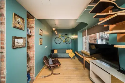a living room with a couch and a bike on the wall at Quiet and Cosy apartment in Kaunas Old Town in Kaunas