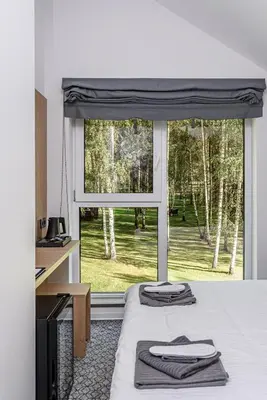 a bedroom with a bed with two towels on it at Molėtairesort in Molėtai