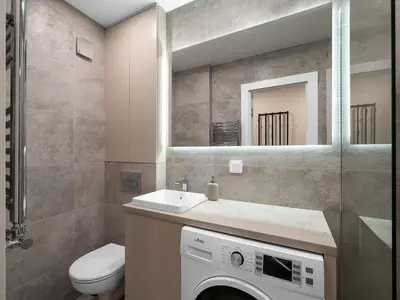 a bathroom with a washing machine and a mirror at Modern 2 bedroom Vytenio apartment in city centre I Self check-in in Vilnius