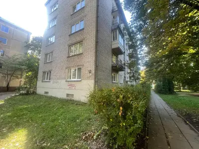 an apartment building with a grassy yard in front of it at Modern 2 bedroom Vytenio apartment in city centre I Self check-in in Vilnius