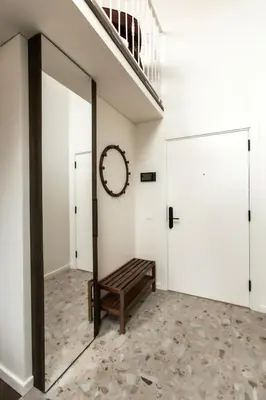 a hallway with a sliding door and a bench at Loft 27 in Kaunas