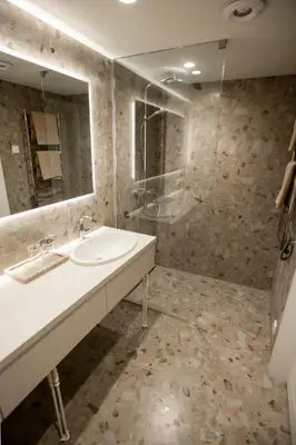 a bathroom with a sink and a mirror and a shower at Loft 27 in Kaunas