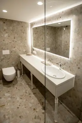 a bathroom with a sink and a toilet and a mirror at Loft 27 in Kaunas