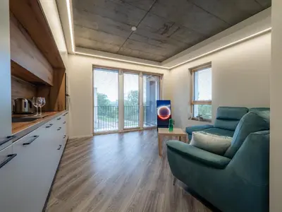 a living room with a couch and a table at Cozy Apartment Vilnius in Vilnius
