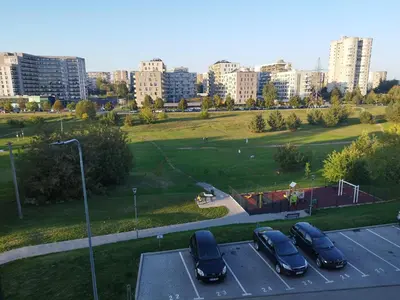 a group of cars parked in a parking lot at Cozy Apartment Vilnius in Vilnius
