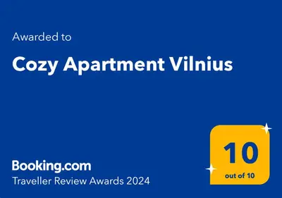 a yellow square with the words cozy apartment villivating on a blue background at Cozy Apartment Vilnius in Vilnius