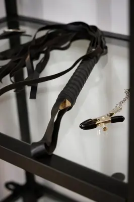 a black rope with a cross and a dagger at Romantic Room Šiauliai in Šiauliai