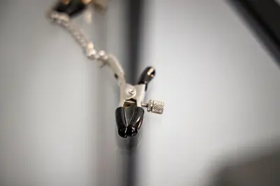 a necklace with a black object on a chain at Romantic Room Šiauliai in Šiauliai