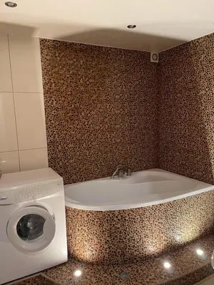 a bathroom with a washing machine and a washer at Dainai Apartments in Šiauliai