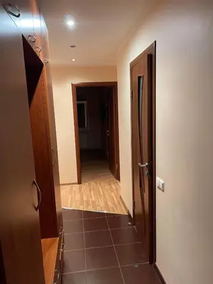 a hallway leading to a room with a door and a hallway at Dainai Apartments in Šiauliai