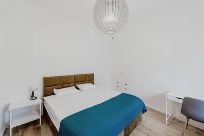a bedroom with a bed and a desk and a chair at Vilnius Old Town Apt Subacius 3. Free Parking in Vilnius