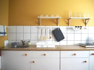 a kitchen with a sink and a counter with utensils at Cozy city center apartment in Visaginas