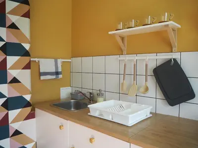 a kitchen with a sink and a counter with utensils at Cozy city center apartment in Visaginas