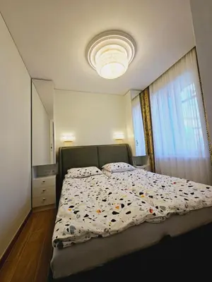 a bedroom with a bed with a comforter on it at Uzupis Riverside Apartment in Vilnius