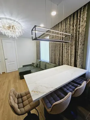 a living room with a table and a couch at Uzupis Riverside Apartment in Vilnius