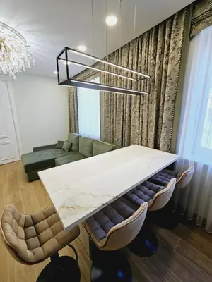 a living room with a table and a couch at Uzupis Riverside Apartment in Vilnius