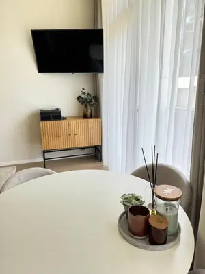 a white table with two bowls of food on it at Moon apartment in Druskininkai