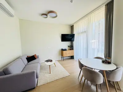 a living room with a couch and a table at Moon apartment in Druskininkai