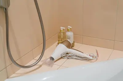 a bathroom sink with a faucet next to a shower at Arena Park Apartment in Kaunas