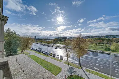 a view of a river with the sun in the sky at Arena Park Apartment in Kaunas
