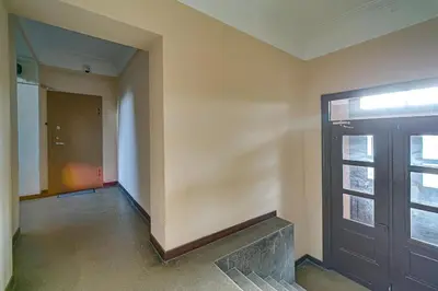 an empty room with a door and a window at Arena Park Apartment in Kaunas