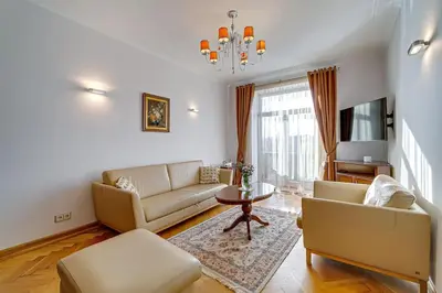 a living room with a couch and a table at Arena Park Apartment in Kaunas