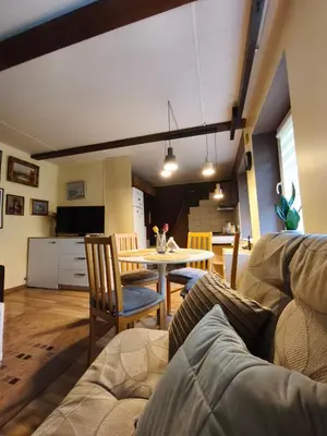 a living room with a couch and a table at Cosy studio apartment with the garden in Druskininkai