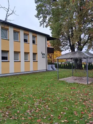 a park in front of a building at Cosy studio apartment with the garden in Druskininkai