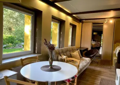 a living room with a couch and a table at Cosy studio apartment with the garden in Druskininkai