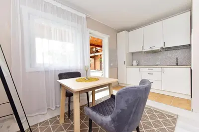 a kitchen and dining room with a table and chairs at Svajonių Dvaras in Balninkai
