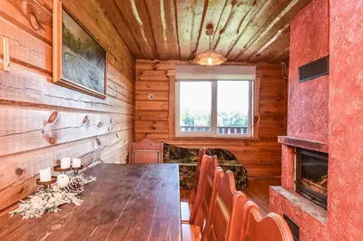 a dining room with a wooden table and chairs at Svajonių Dvaras in Balninkai