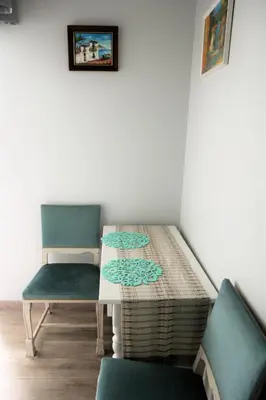 a table and two chairs in a room at Studio apartment in Jeruzalė in Vilnius