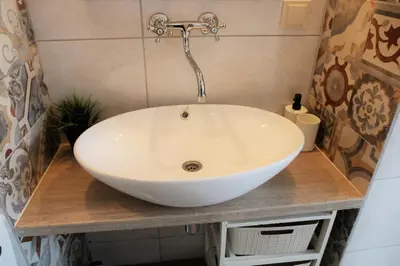 a white sink on a counter in a bathroom at Studio apartment in Jeruzalė in Vilnius