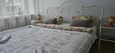 a bedroom with a white bed with pillows on it at Studio apartment in Jeruzalė in Vilnius