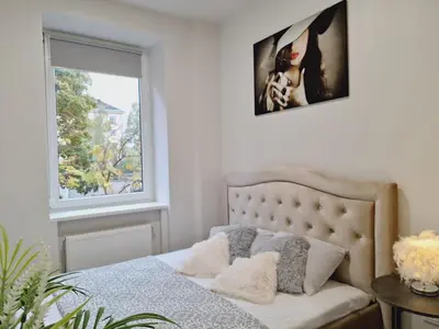 a bedroom with a bed and a window at Kaunas Center Studio in Kaunas