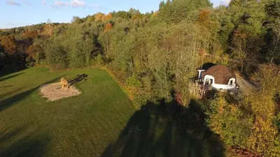 an aerial view of a house in the middle of a field at Kupolinis namelis in Kilova II