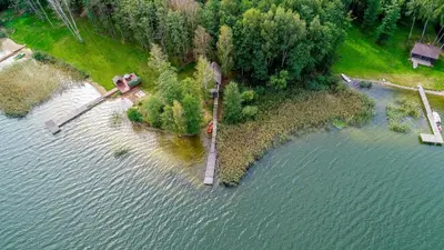 an aerial view of an island in a body of water at Lakeshore house in Dvarčėnai