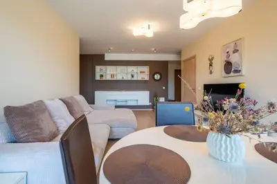 a living room with a couch and a table at Aqua House in Druskininkai