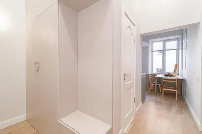 a hallway with a white door and a table at #stayhere - Authentic & Artsy Studio in Heart of Vilnius Old Town in Vilnius
