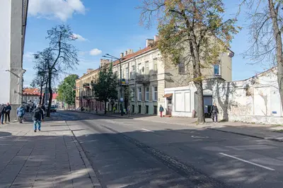 an empty city street with people walking down the street at #stayhere - Authentic & Artsy Studio in Heart of Vilnius Old Town in Vilnius