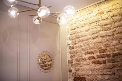 a room with a brick wall and a ceiling at Charming apartment next to the Church of St Anne by Reside Baltic in Vilnius