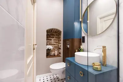 a bathroom with a blue cabinet and a sink at Charming apartment next to the Church of St Anne by Reside Baltic in Vilnius